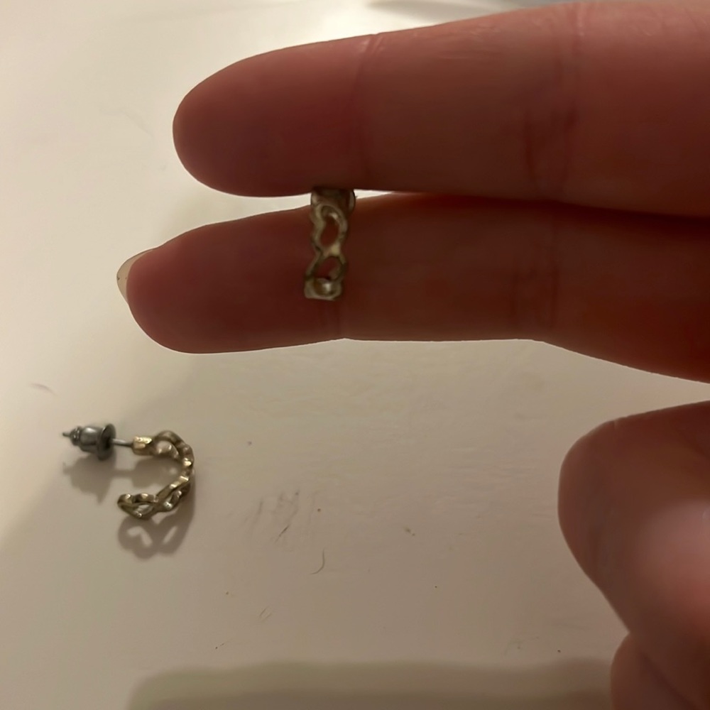 Silver heart loop like earrings white backs.